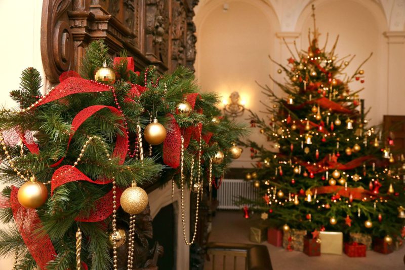 Christmas tree decorated at Wivenhoe House Hotel with gold decorations and red ribbon